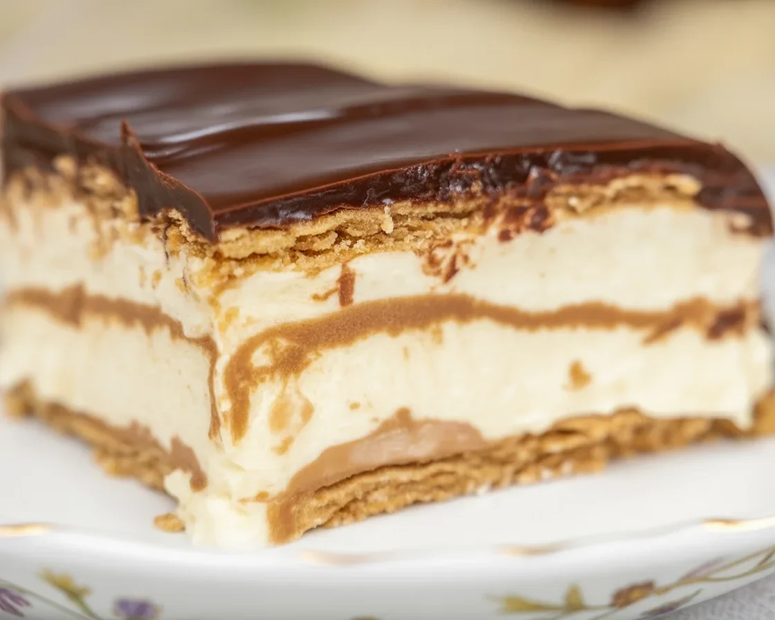 Delicious no-bake Boston cream pie bars with layers of cookie crust, custard, and chocolate.