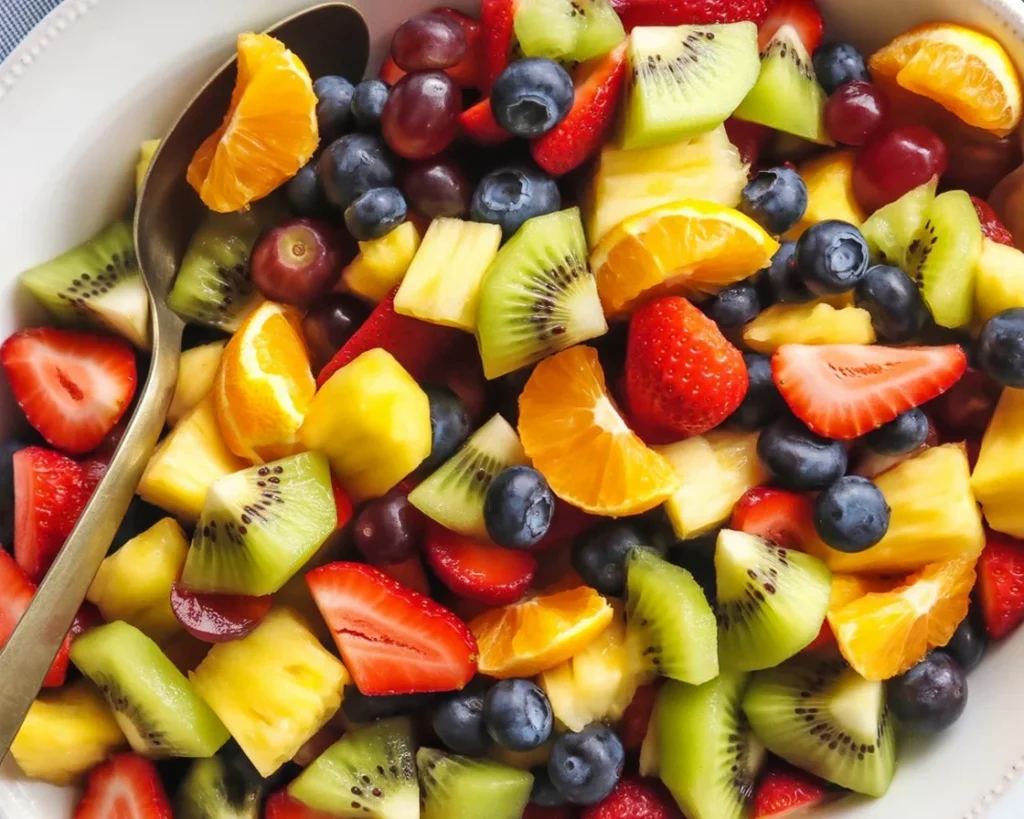 Fresh fruit salad with colorful fruits and honey-lime dressing.